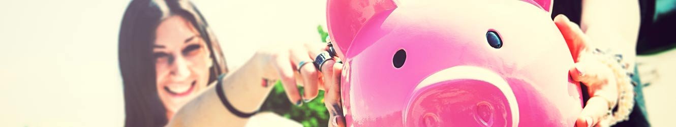 Women holding a piggy bank.